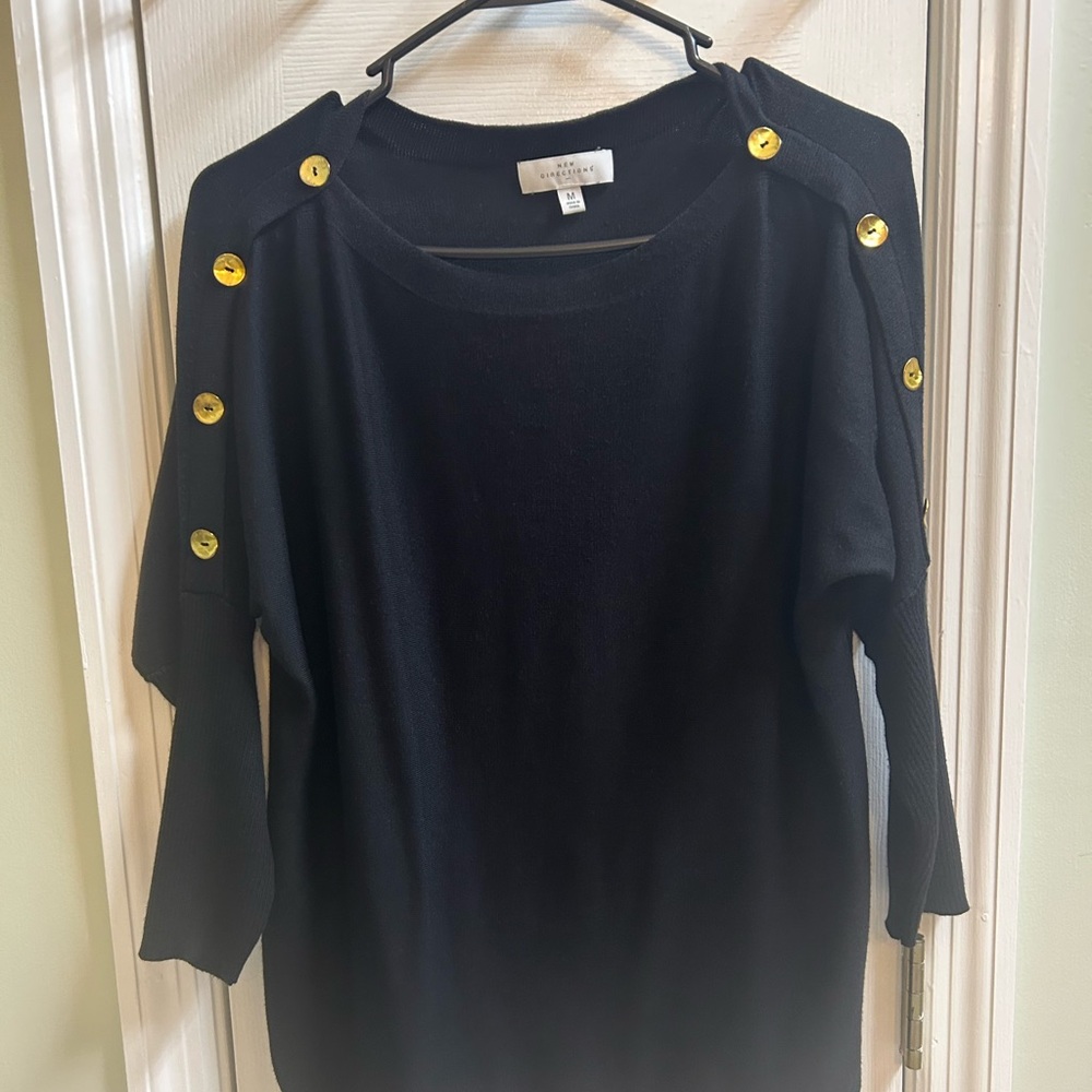 Women's size medium black top, with some button accents on the sleeves.